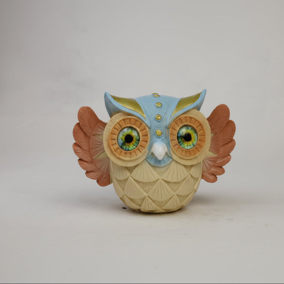 Decorative owl figurine - back view with orange and gold ear tufts and spread wings