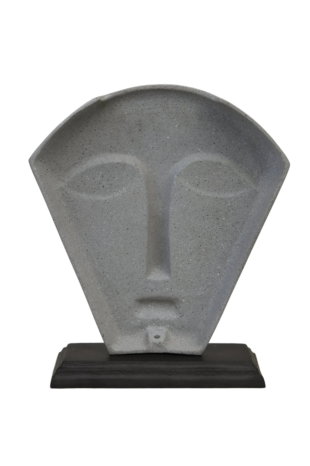 Abstract stone face mask sculpture in speckled concrete grey on dark wood base - slight angle view