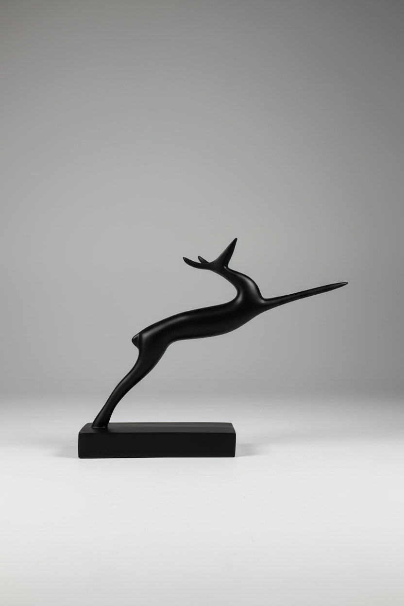 Abstract leaping gazelle sculpture in matte black finish on matching base