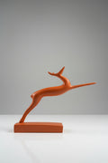 Abstract leaping gazelle sculpture in terracotta matte finish on matching base