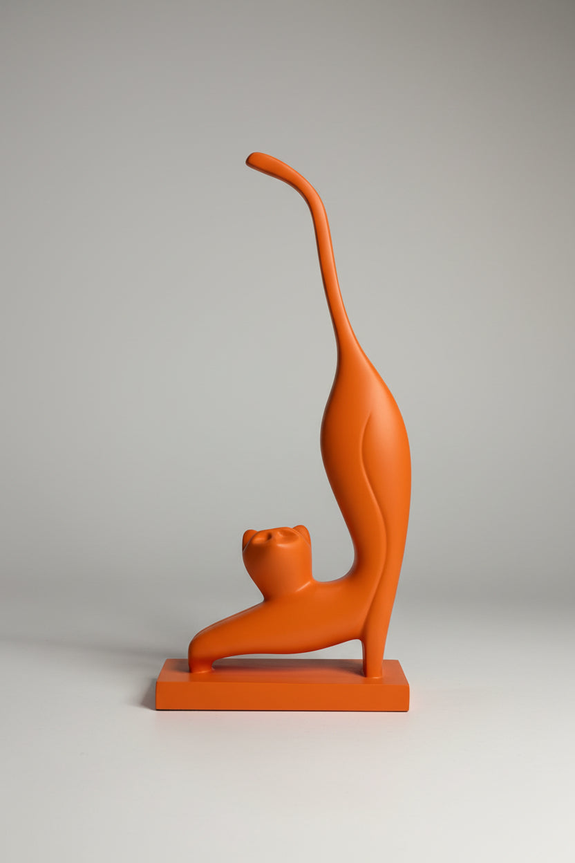 Abstract stretching cat sculpture in orange matte finish on matching base