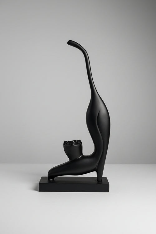 Abstract stretching cat sculpture in matte black finish on matching base