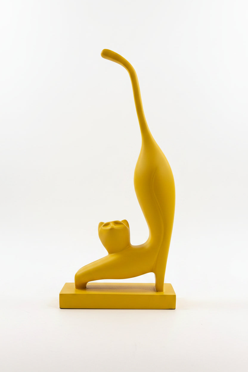 Abstract stretching cat sculpture in yellow matte finish on matching base